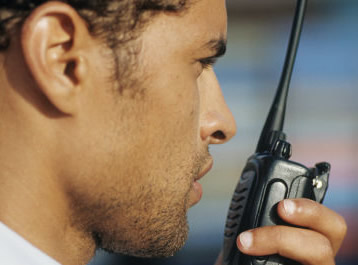 Man talking on hand held radio